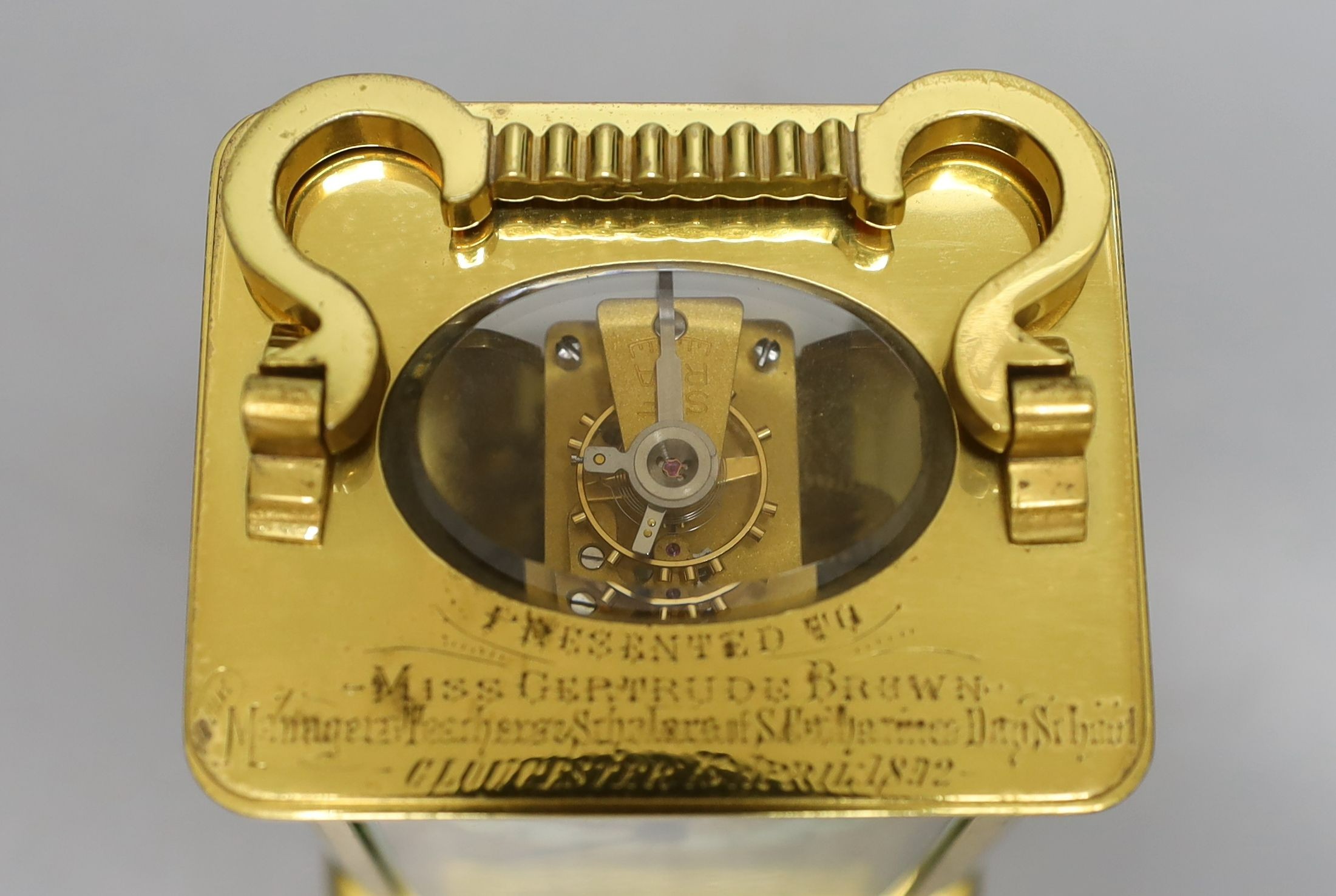 A cased French gilt brass carriage timepiece with relief cast dial and engraved presentation inscription - 14cm tall